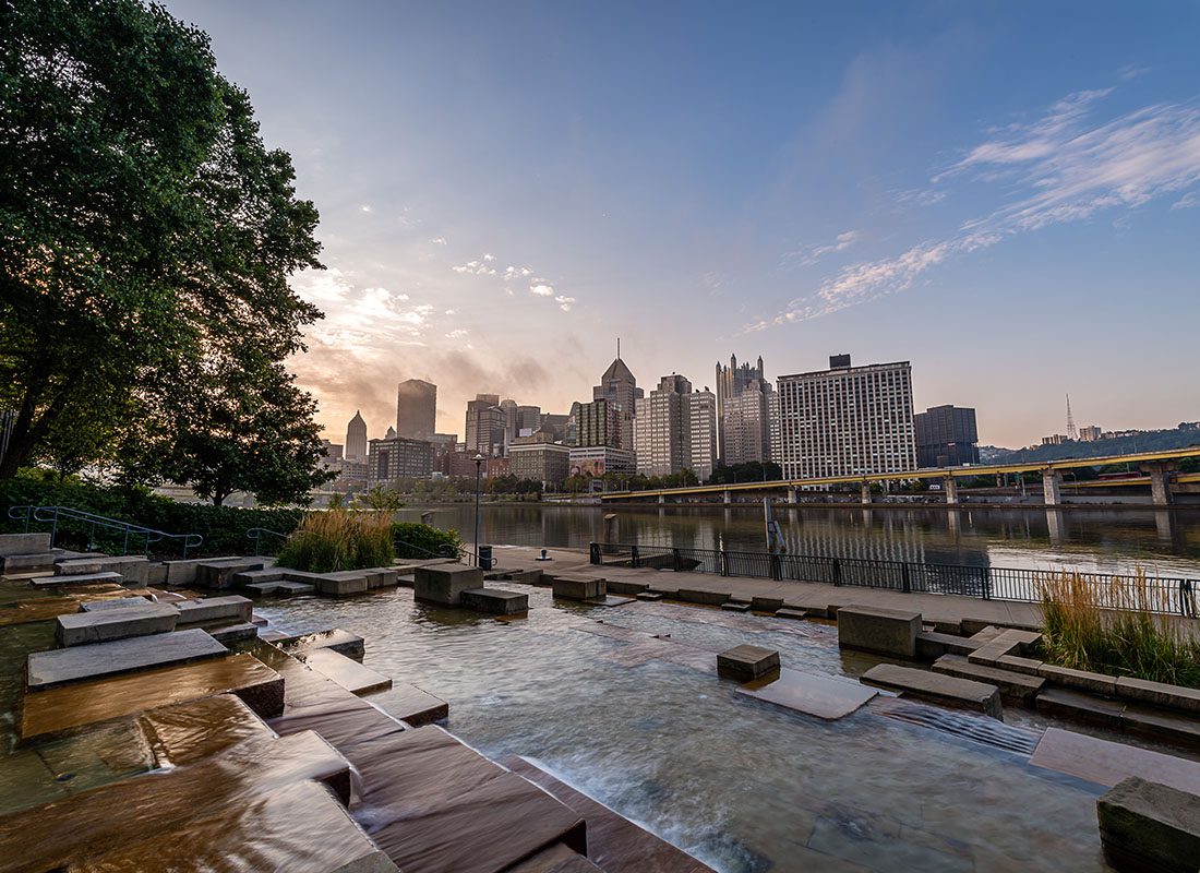 Contact - View of Downtown Pittsburgh Skyline from a Park Next to the Allegheny River at Sunset