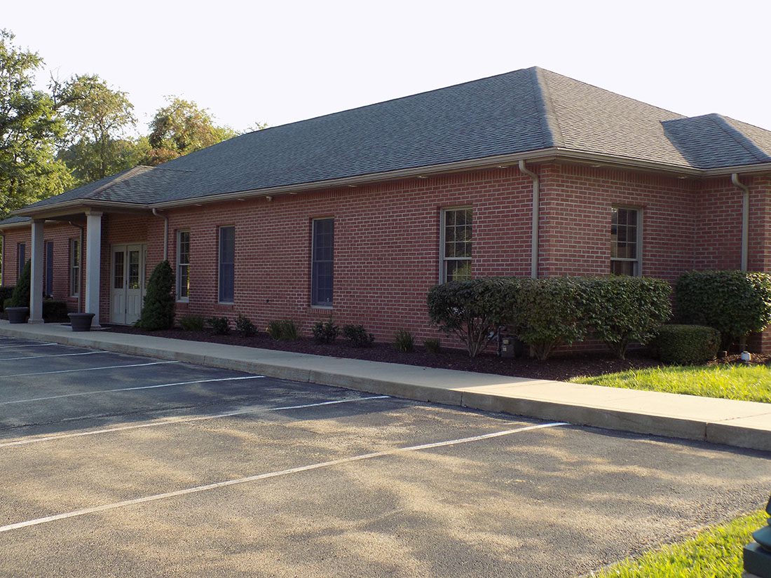 Murrysville, PA - Exterior View of Sebak Insurance Office Building with Empty Parking Lot on a Sunny Day in Murrysville Pennsylvania